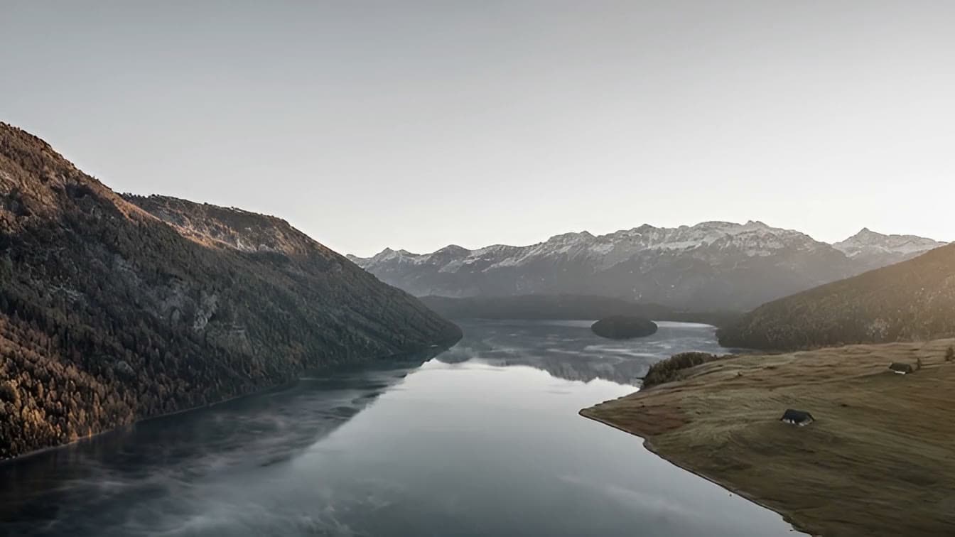 Alpine lake in morning mist, seen from above